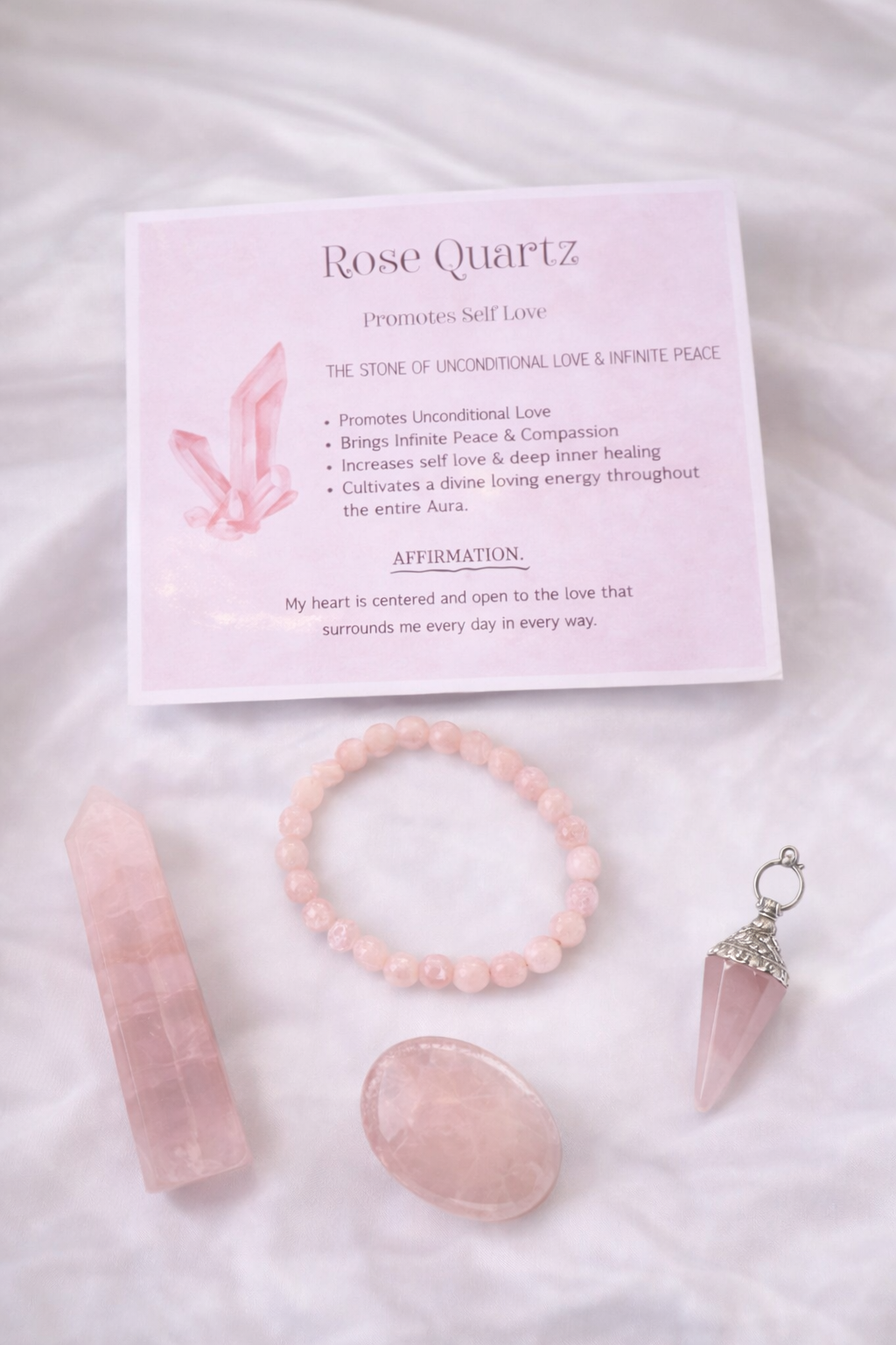 Rose Quartz crystal set with card on a soft pink background