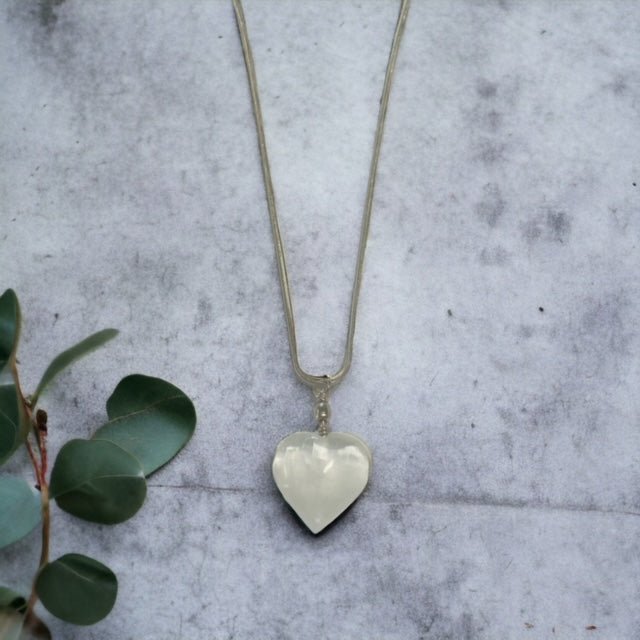 Polished selenite heart pendant on chain, gemstone necklace for clarity and calm.