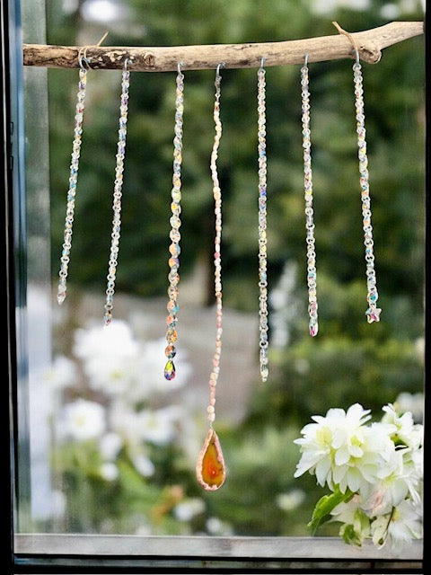 Boho celestial sun catcher accessory with hanging crystals to reflect light and create rainbows