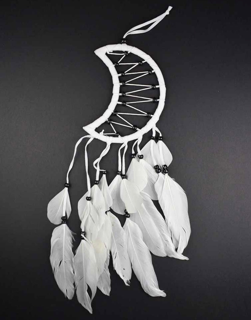 A white 5cm dream catcher in the shape of a crescent moon with feather-like details, against a black background.