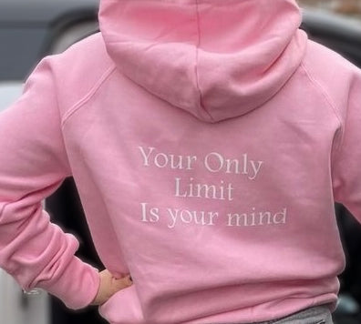 A pink hoodie with the text 'YOUR ONLY LIMIT IS YOUR MIND' printed on the front.
