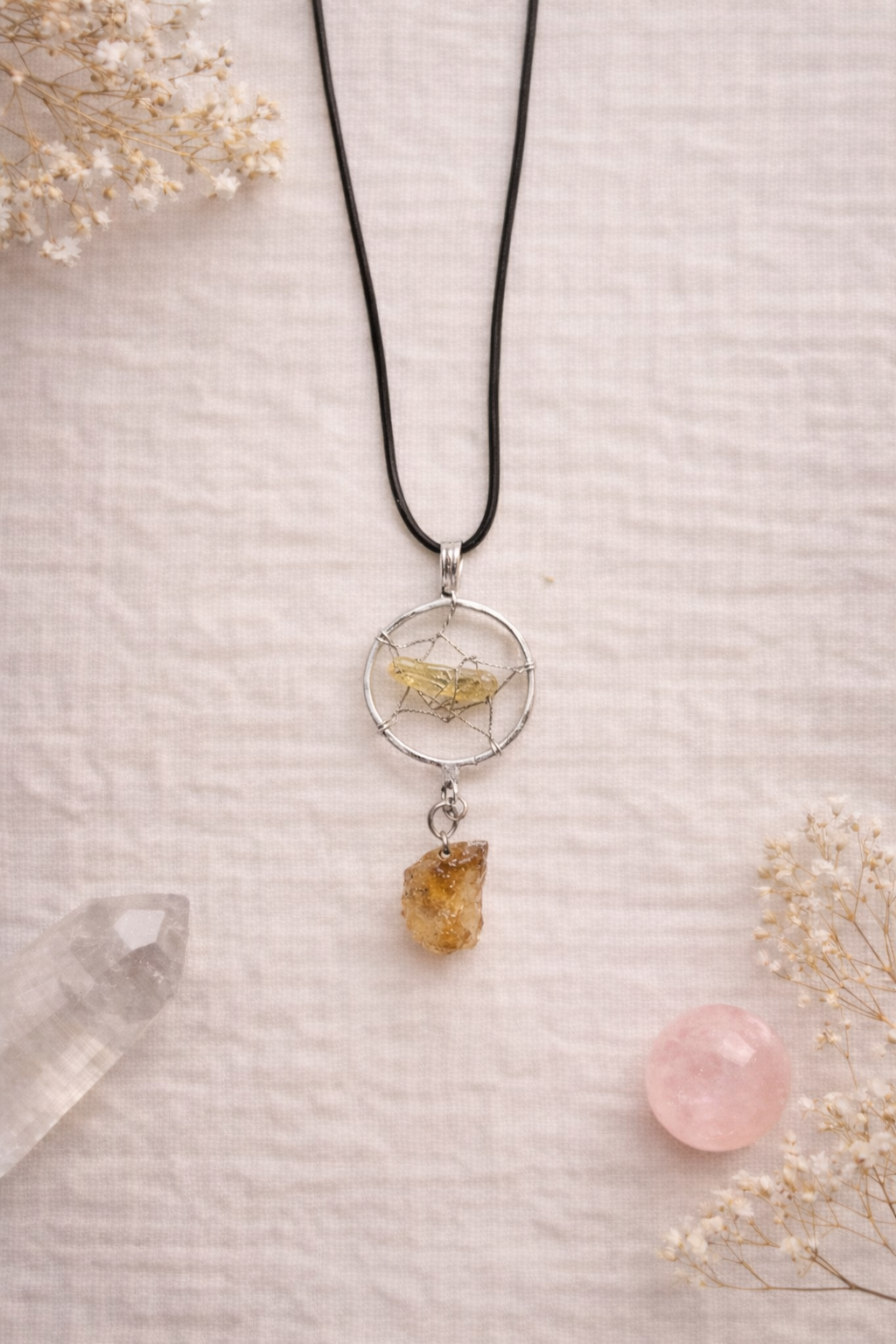 dream catcher cord necklace with citrine gemstone on linen with dried flowers and crystals