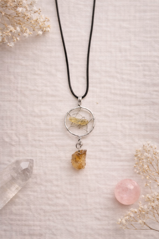 dream catcher cord necklace with citrine gemstone on linen with dried flowers and crystals