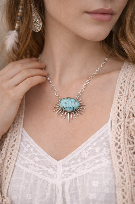 woman wearing turquoise sun shaped pendant 