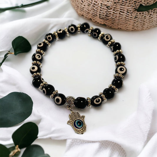 Evil eye beaded bracelet with Hamsa hand charm, spiritual jewellery for protection and good luck.