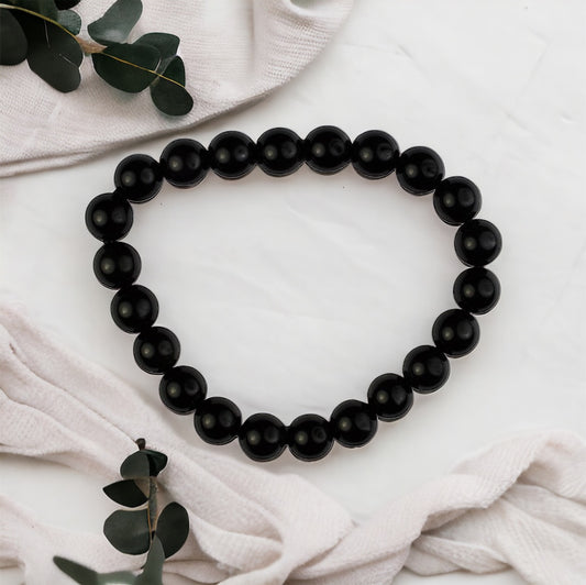 Healing rainbow obsidian gemstone bead bracelet, spiritual accessory for balance and strength.