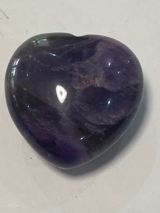 Mini amethyst crystal heart, pocket-sized healing stone for peace, calm and spiritual protection.